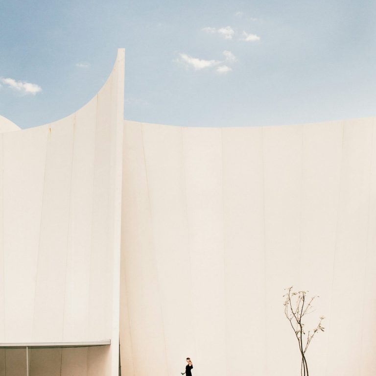 Minimalist curved building exterior representing reflection and final steps in the Vista Community Clinic grievance process