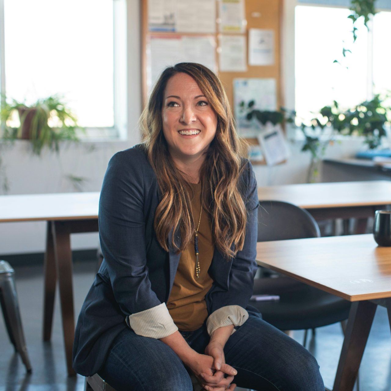 Woman sitting in office representing patients seeking Vista Community Clinic locations, addresses, and phone numbers